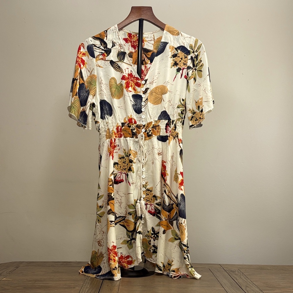 Floral on cream background dress.
Button Down with a tie waist.